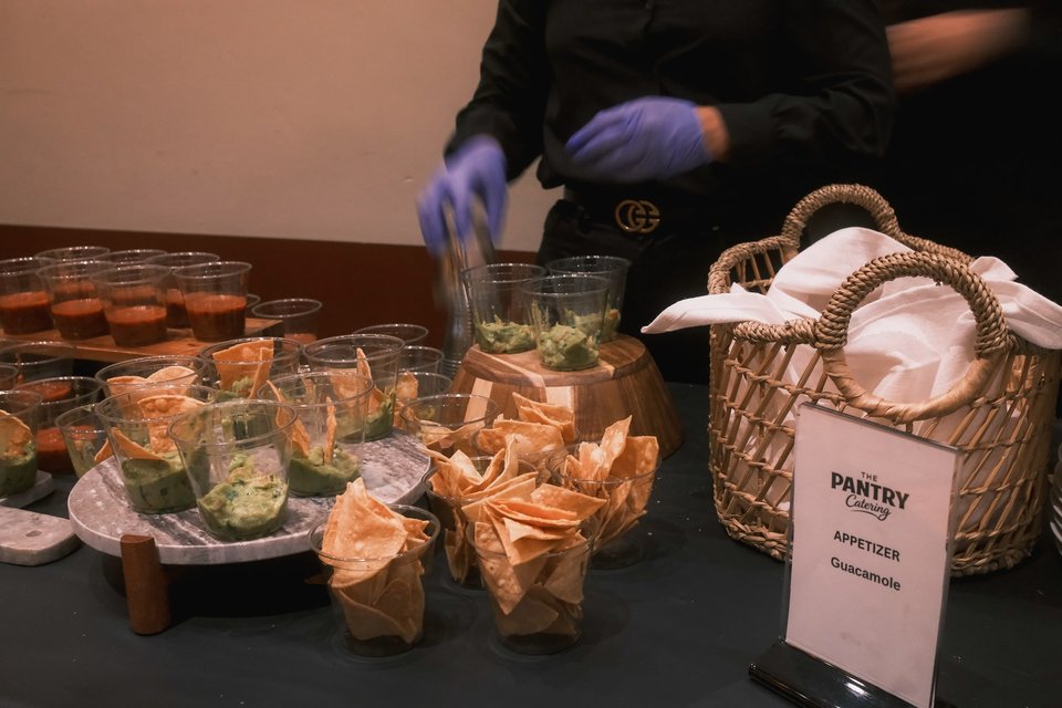 Chips, dips, and tableware prepared by The Pantry Catering for an event
